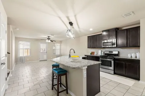 a kitchen with stainless steel appliances granite countertop a stove a sink dishwasher a microwave oven with granite countertops and cabinets