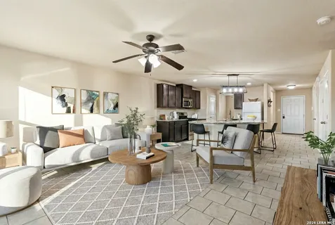 a living room with lots of furniture and view of kitchen