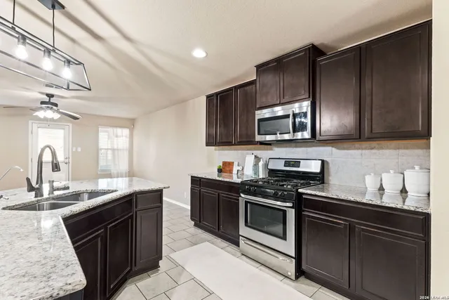 a kitchen with a sink stove and microwave