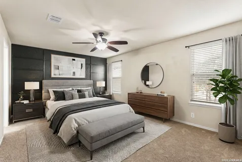 a bedroom with a bed a chandelier and dresser
