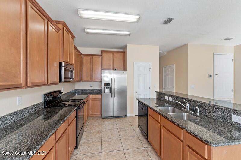 Undisclosed Address Melbourne, FL 32935 - Photo 3 of 17 02_2725RevolutionSt_101_5_Kitchen_FlexML