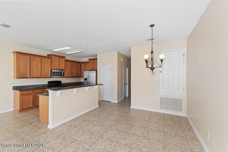 Undisclosed Address Melbourne, FL 32935 - Photo 4 of 17 03_2725RevolutionSt_101_2_DiningRoom_Fle
