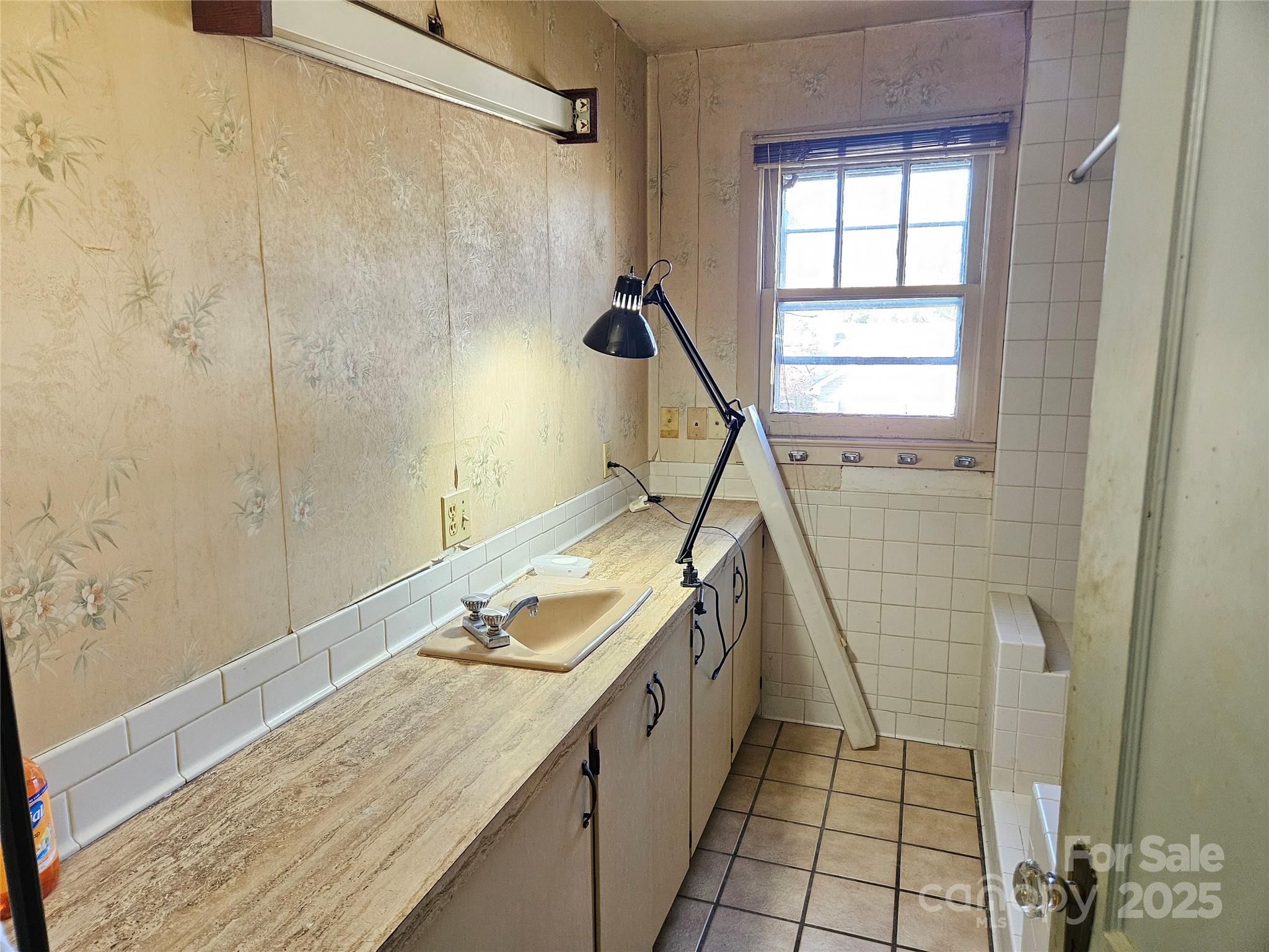 101 Edgewood Avenue Morganton, NC 28655 - Photo 12 of 32 a bathroom with a sink a vanity and a shower