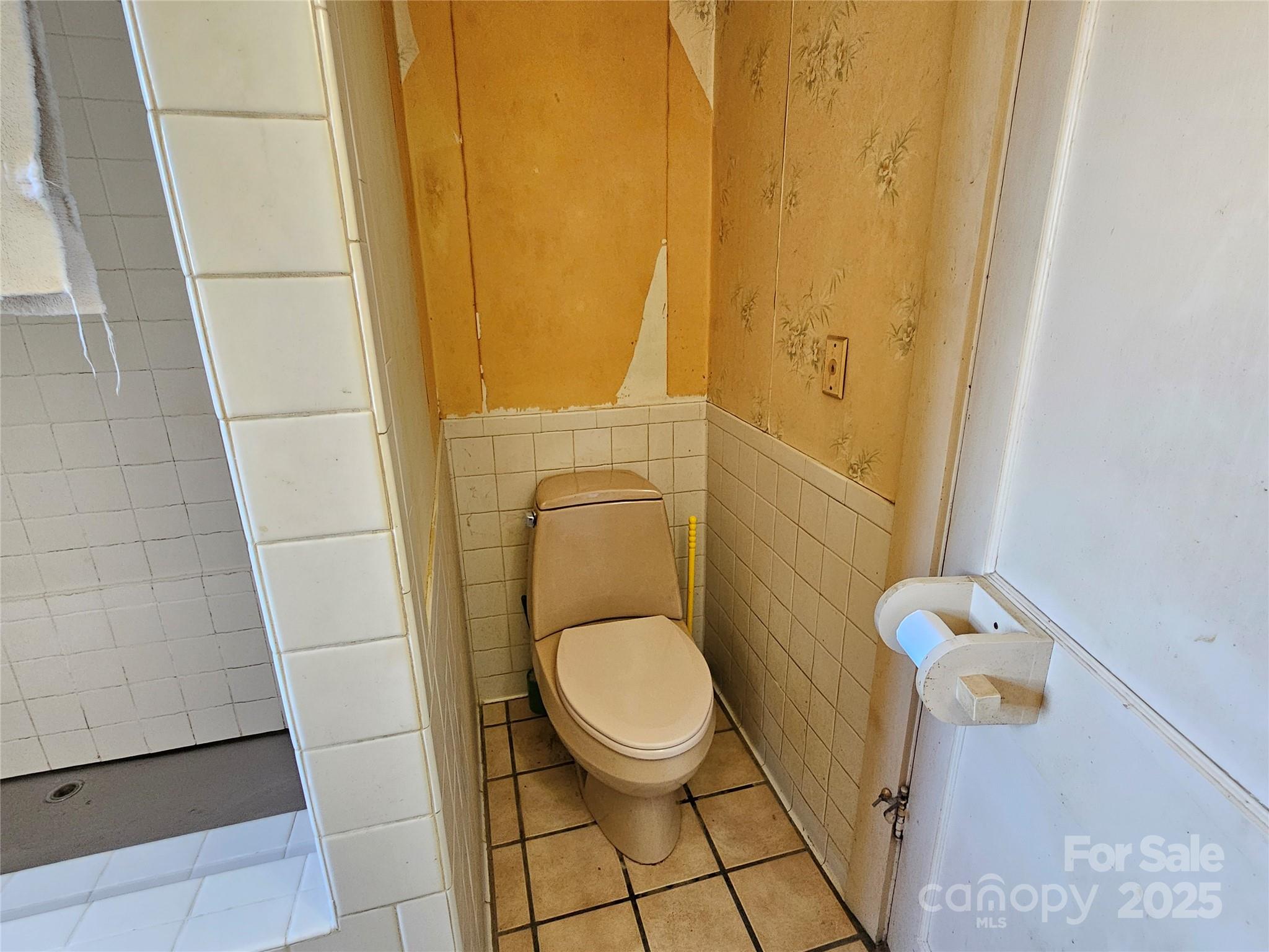 101 Edgewood Avenue Morganton, NC 28655 - Photo 14 of 32 a white toilet sitting next to a shower