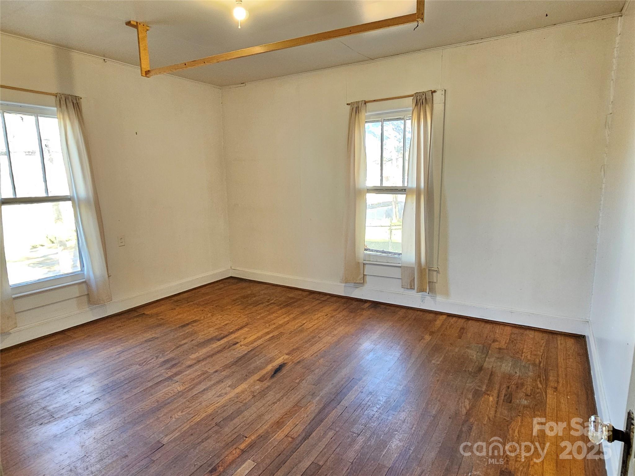 101 Edgewood Avenue Morganton, NC 28655 - Photo 15 of 32 an empty room with wooden floor and windows