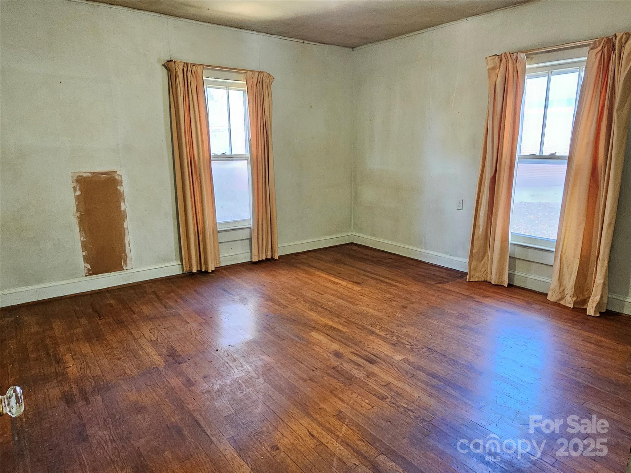 101 Edgewood Avenue Morganton, NC 28655 - Photo 16 of 32 an empty room with wooden floor and window