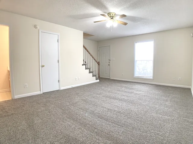 a view of empty room with ceiling fan