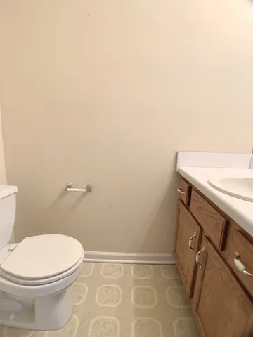a bathroom with a sink a toilet and vanity