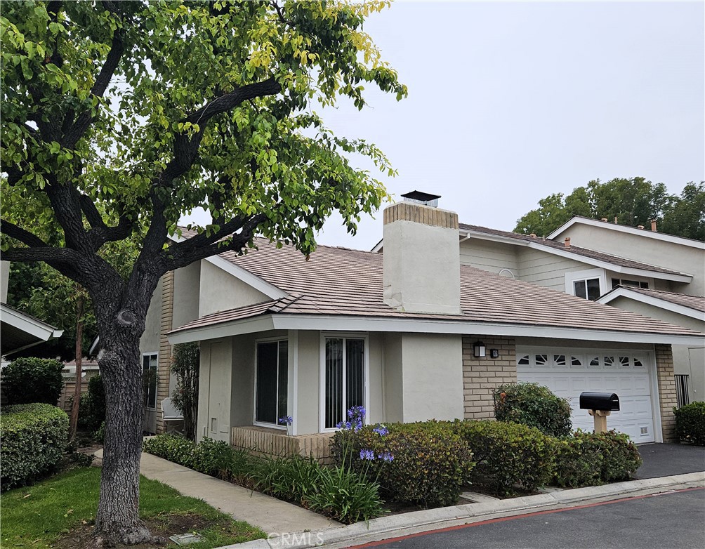 17 Cresthaven, Unit 48 Irvine, CA 92604 - Photo 1 of 1 a front view of a house with a garden