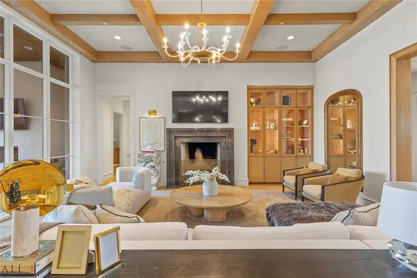 a living room with furniture a fireplace and flat screen tv