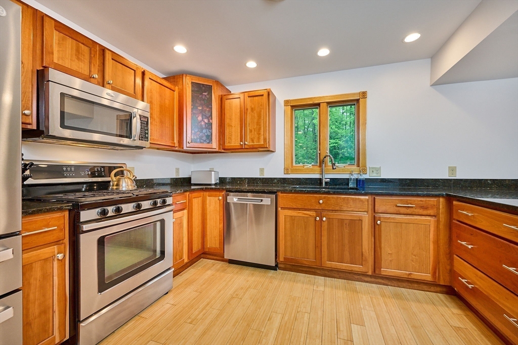 88 High Point Drive Amherst, MA 01002 - Photo 11 of 35 a kitchen with stainless steel appliances granite countertop a stove a sink and a microwave