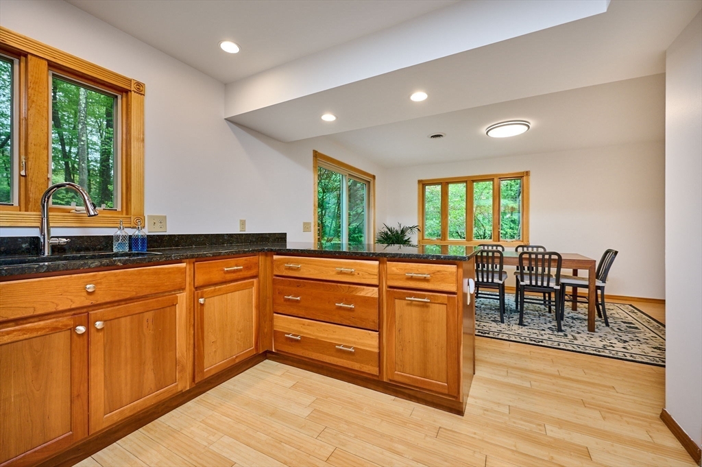 88 High Point Drive Amherst, MA 01002 - Photo 12 of 35 a kitchen with stainless steel appliances granite countertop wooden cabinets a stove a sink and a large window