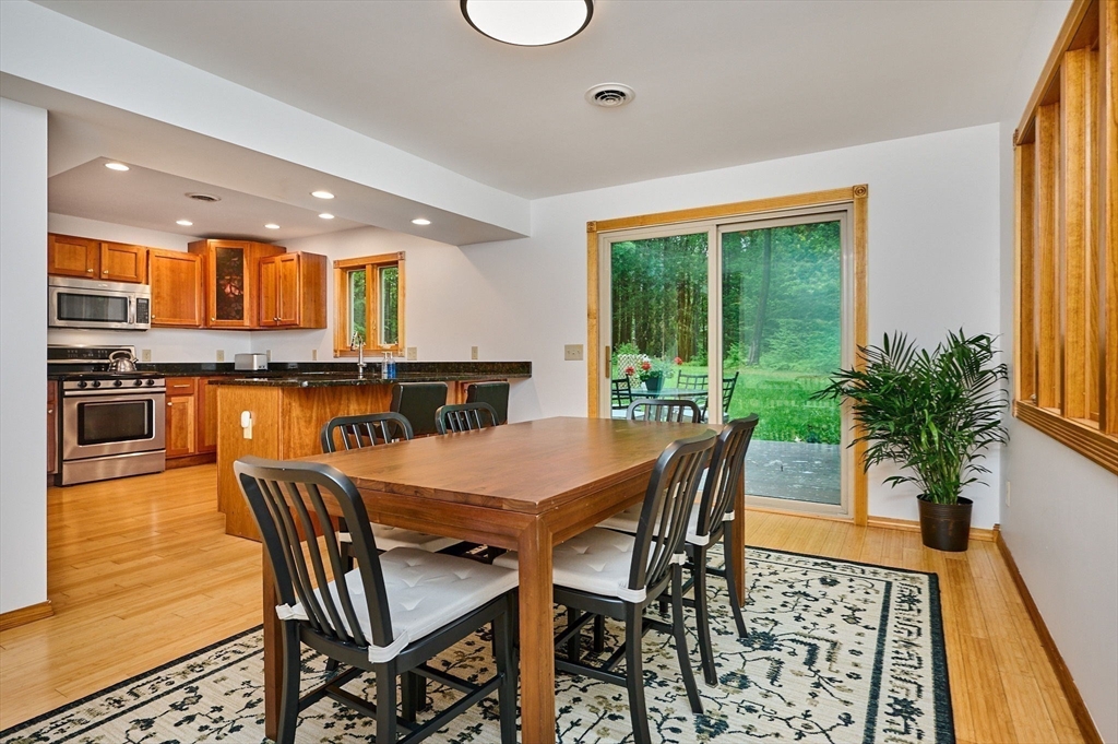 88 High Point Drive Amherst, MA 01002 - Photo 15 of 35 a view of a dining room with furniture and a potted plant