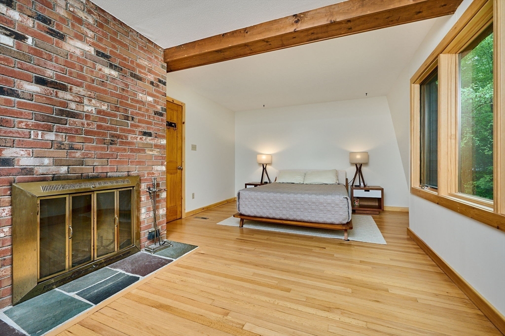 88 High Point Drive Amherst, MA 01002 - Photo 19 of 35 a spacious bedroom with a bed and wooden floor