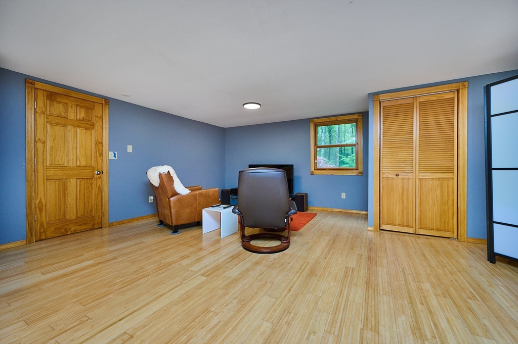 88 High Point Drive Amherst, MA 01002 - Photo 26 of 35 a bedroom with a bed and wooden floor
