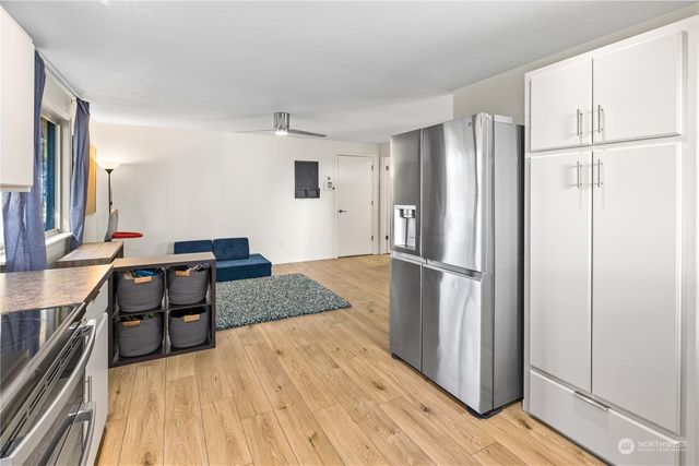 a kitchen with a refrigerator and a stove top oven