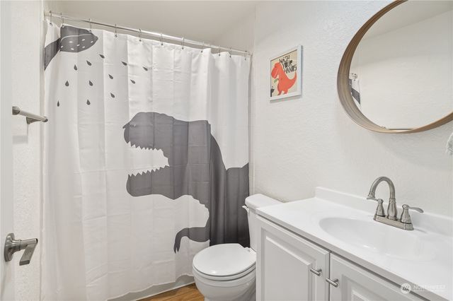 a bathroom with a sink toilet and a mirror