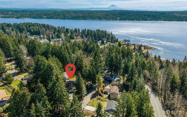 an aerial view of a house with a lake view