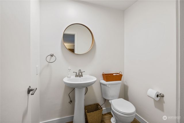 a bathroom with a toilet sink and mirror