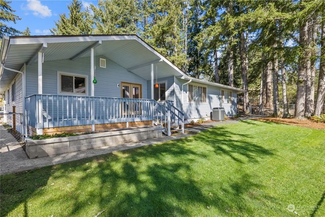a view of a house with a yard and sitting area