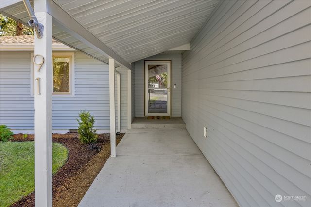 a view of a porch with wooden walls and stairs