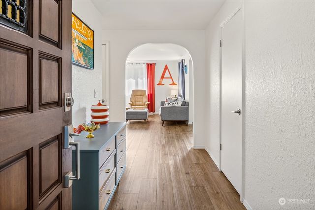 a view of living room with furniture and wooden floor