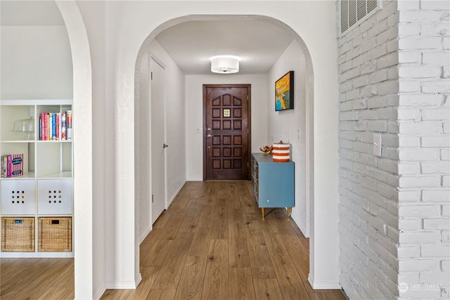 a view of an entryway with wooden floor