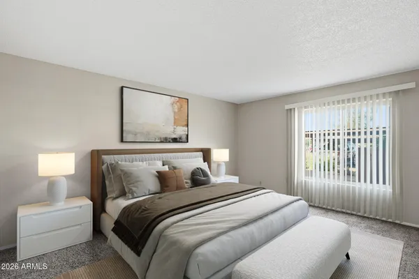 a bedroom with a bed and a lamp