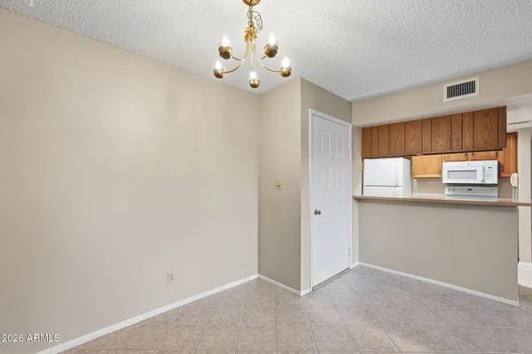 a view of kitchen with granite countertop cabinets and window
