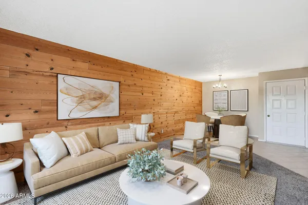 a living room with furniture and wooden floor