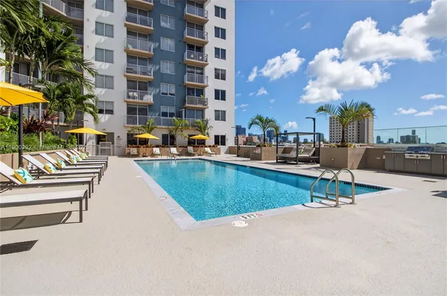 a view of a swimming pool with outdoor seating