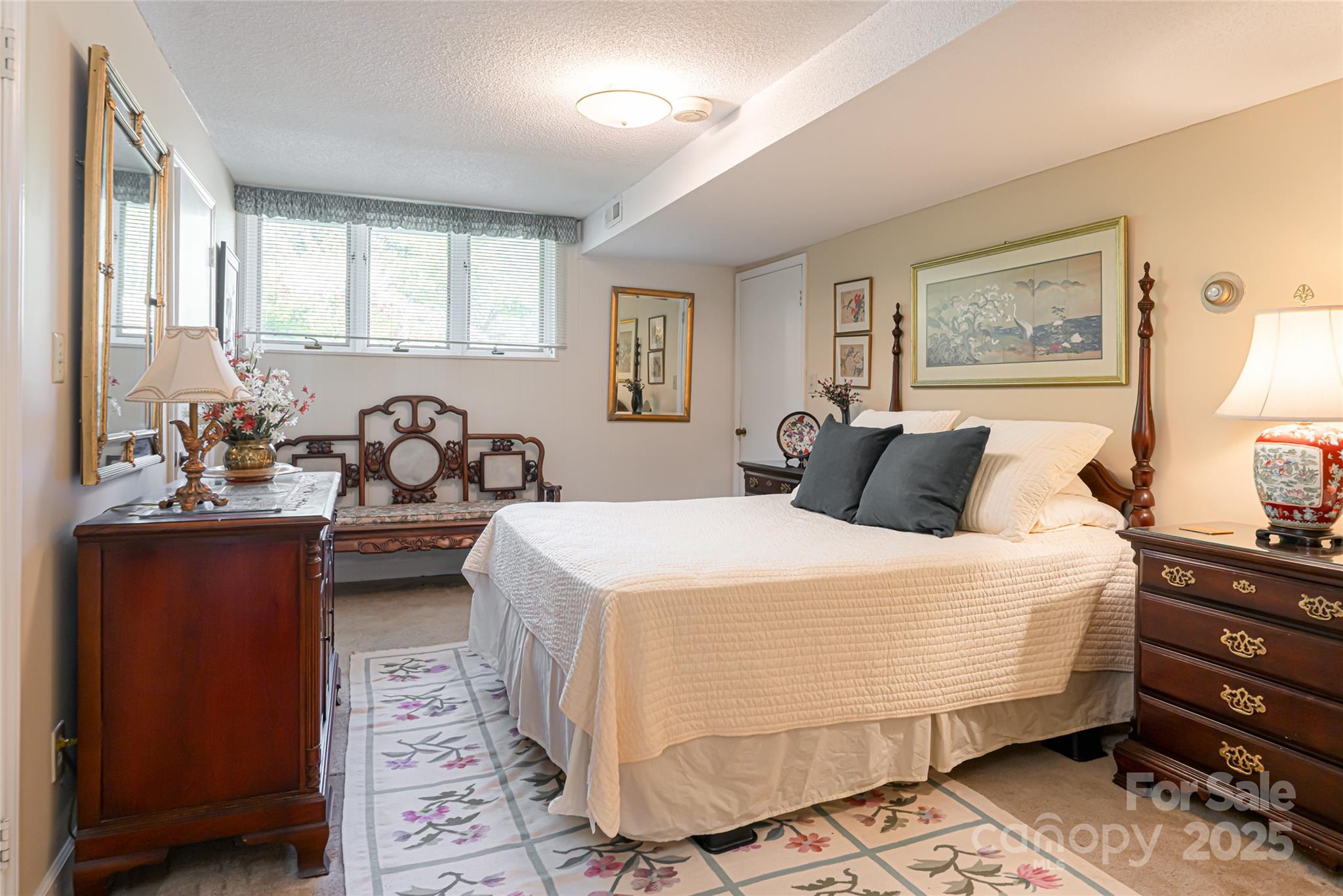 69 Forest Road Asheville, NC 28803 - Photo 22 of 48 a bedroom with a bed and wooden floor
