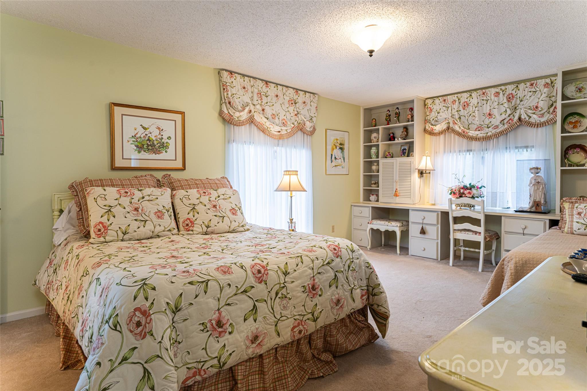 69 Forest Road Asheville, NC 28803 - Photo 32 of 48 a bedroom with a bed and ceiling fan