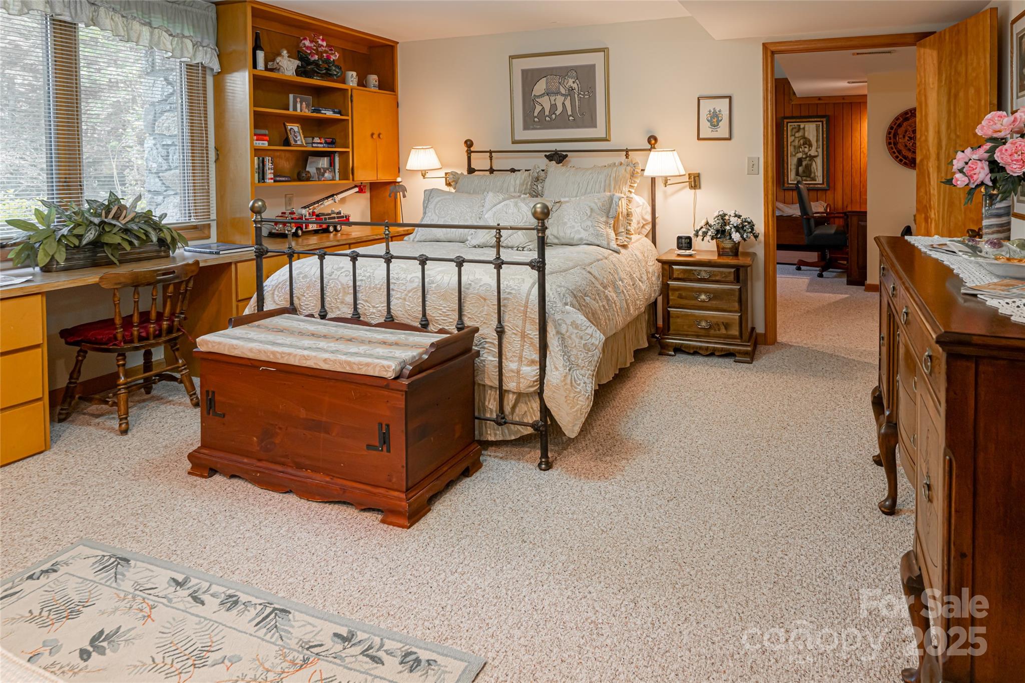 69 Forest Road Asheville, NC 28803 - Photo 36 of 48 a spacious bedroom with a bed and a table in it