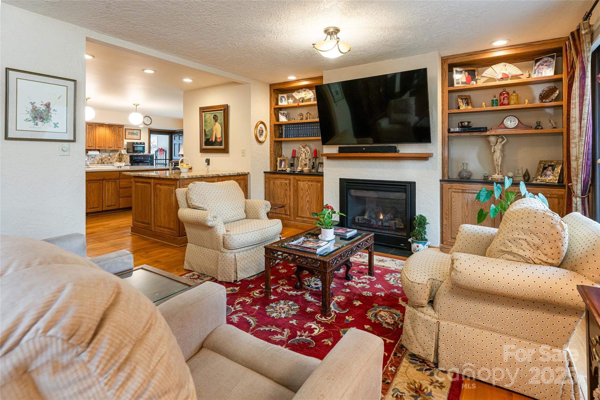 69 Forest Road Asheville, NC 28803 - Photo 6 of 48 a living room with fireplace furniture and a flat screen tv