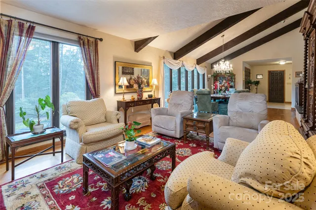 a spacious bedroom with two beds and large window