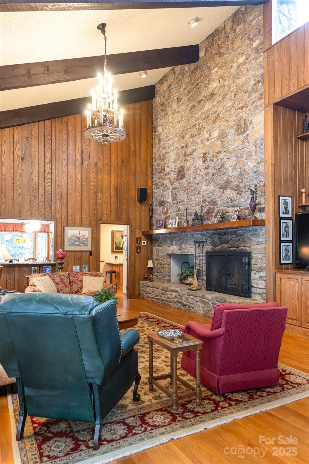 69 Forest Road Asheville, NC 28803 - Photo 9 of 48 a living room with furniture a fireplace and a chandelier