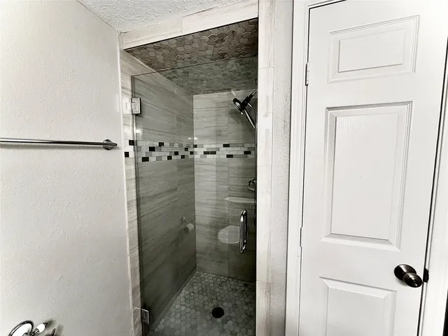 a bathroom with a glass shower door
