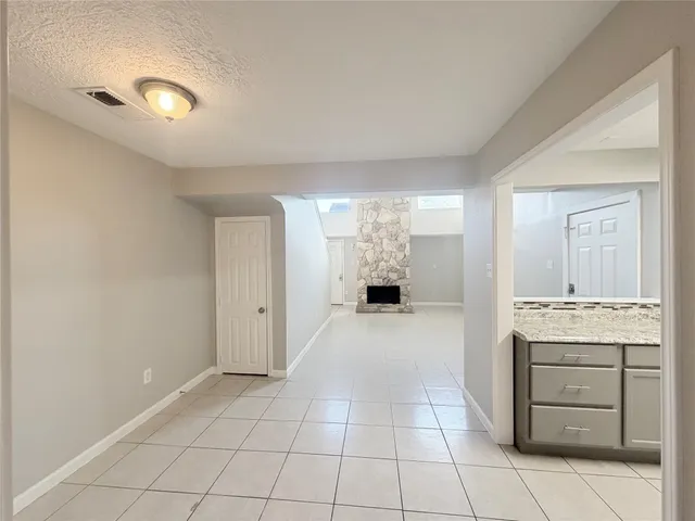 a view of a kitchen with white cabinets