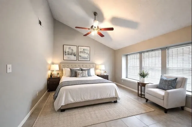 a bedroom with a bed couch and window