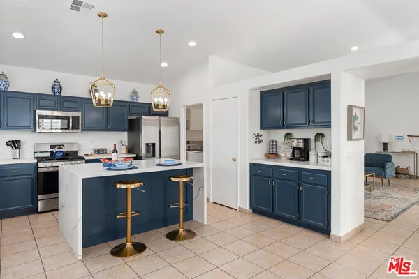 a kitchen with cabinets and window