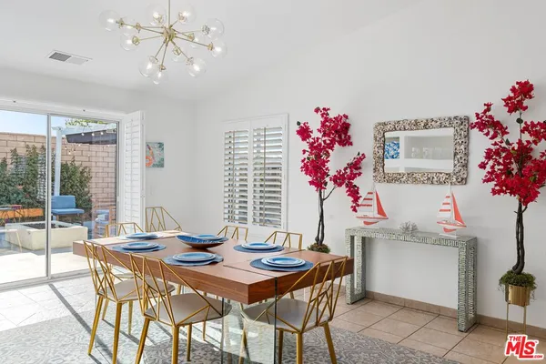 a view of a dining room with furniture and chandelier