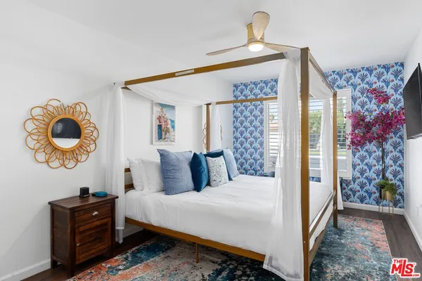 a bedroom with a bed and a chandelier