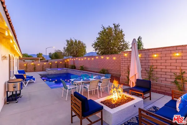 a view of an outdoor sitting area with brick walls