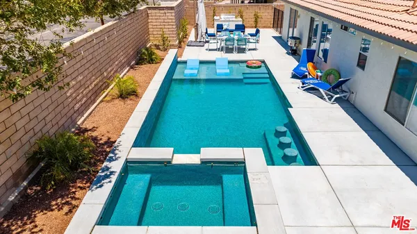 a view of swimming pool with seating area