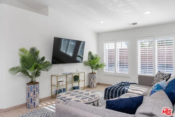 a living room with furniture and a potted plant