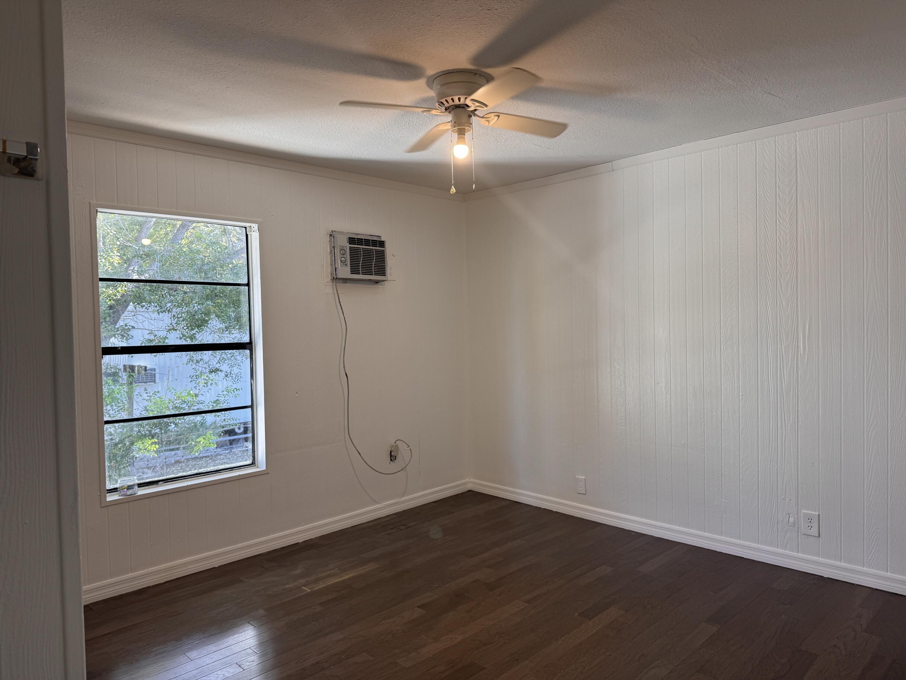 969 Plantation Road Key Largo, FL 33037 - Photo 9 of 26 an empty room with wooden floor and windows