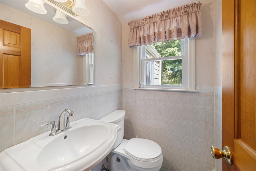 40 Bell Road Weymouth, MA 02188 - Photo 17 of 41 a bathroom with a sink a toilet and a mirror