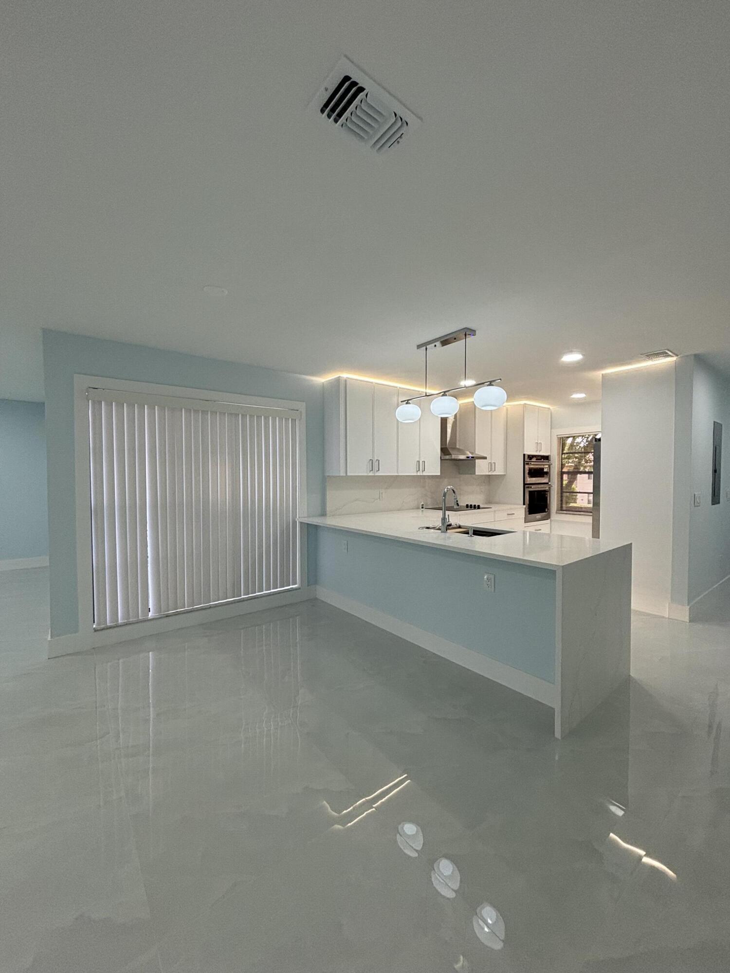 9266 Vista Del Lago, Unit 25H Boca Raton, FL 33428 - Photo 12 of 38 a bathroom with a sink a mirror and a bathtub