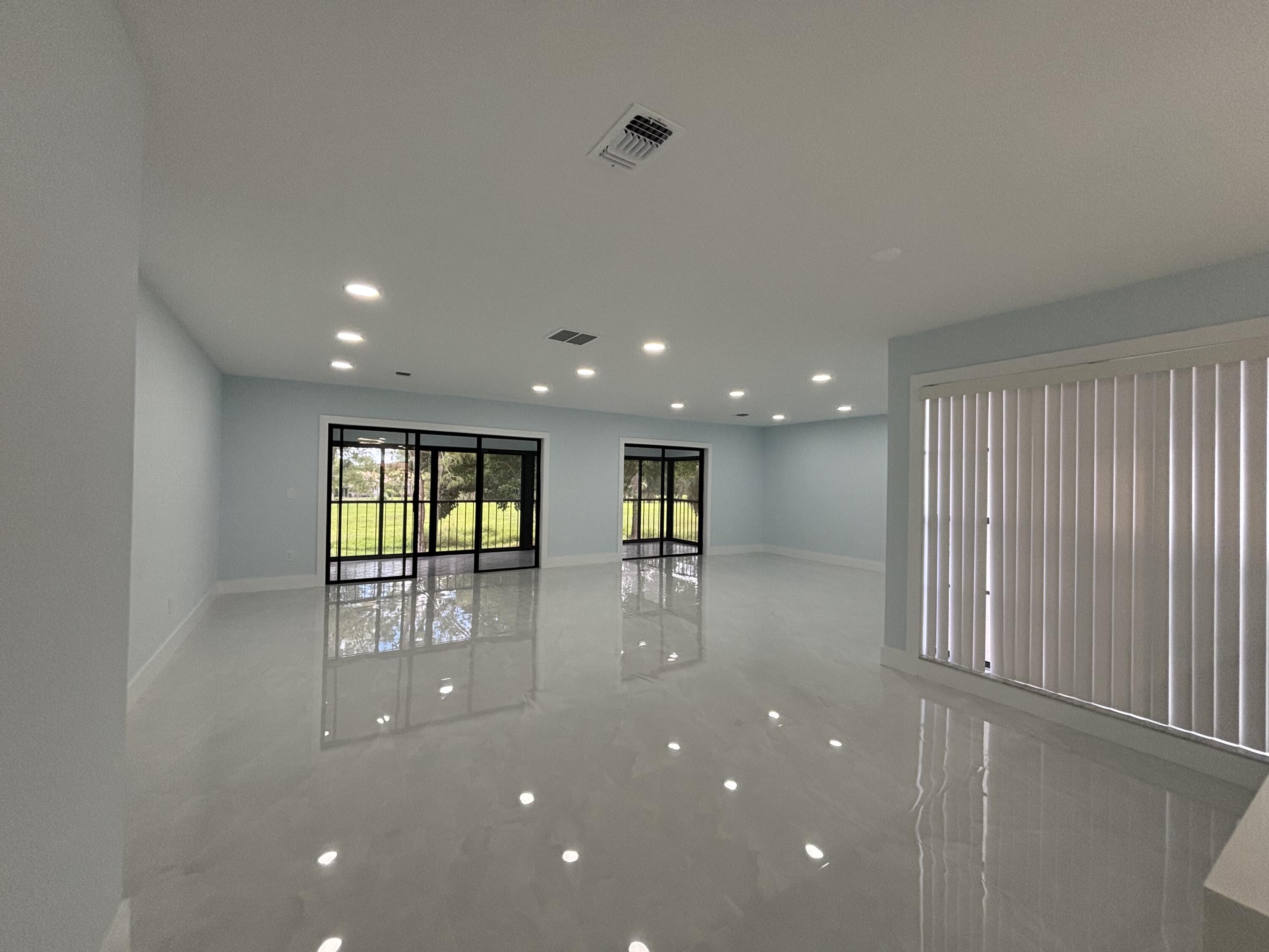 9266 Vista Del Lago, Unit 25H Boca Raton, FL 33428 - Photo 13 of 38 a view of empty room with wooden floor and fan